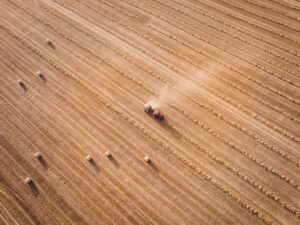 aerial photograph of a tractor working in a wheat field
